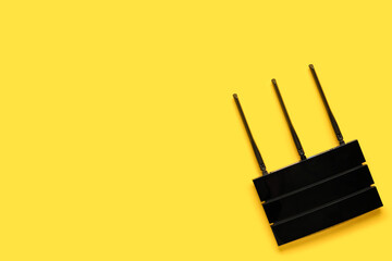 Modern wi-fi router on yellow background