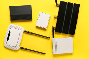 Modern wi-fi routers on yellow background