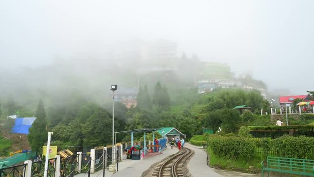 Darjeeling, West Bengal,India-20.08.2023 : 4K video of monsoon clouds passing over Himalayan mountains at Batasia loop. Darjeeling is queen of hills, very scenic with nice green hills in rainy season.