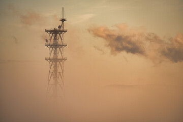Hokkaido, Japan - November 16, 2023: Radio tower partially covered with morning haze in winter in Asahikawa, Hokkaido, Japan
