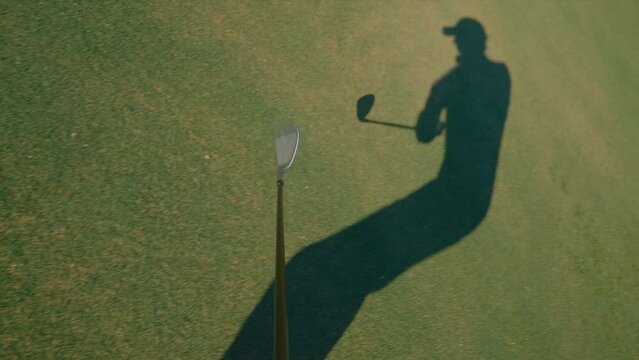 Golf chip shot from golf club POV, chipping from the fringe with wedge locked off view on sunny day in slow motion