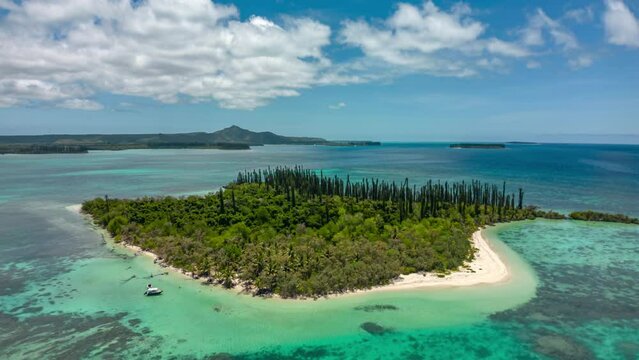 Boats take tourists to Ile Moro in New Caledonia - uninhabited island paradise aerial orbit hyper lapse
