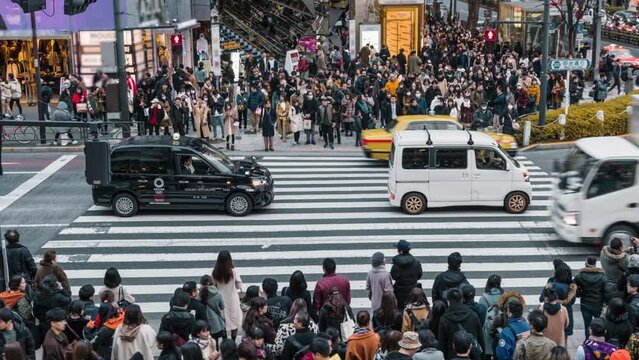 Large group of Pedestrian crossing road with traffic in Tokyo, Japan, 4k time lapse clip
