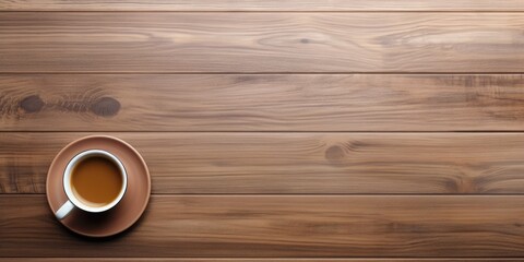 Top-down view of wooden desk with coffee and notebook, room for additional content.