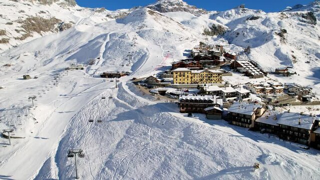 Panoramic aerial drone scenic view at ski slopes, mountain skiing and popular resort town. Italian ski resort in Alps in Aosta Valley in winter. Winter landscape. Italy, Breuil Cervinia. 4K video.