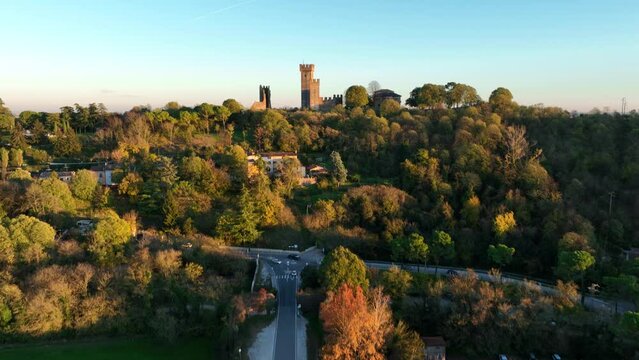 Aerial Bottom up Forward Drone Shot, of Valeggio's Castle over Visconteo's Bridge with cars Crossing at Golden Hour