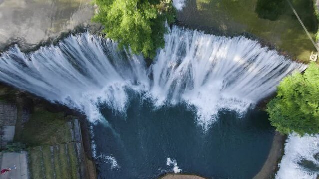 Aerial rising over huge waterfall Pliva in Jajce, Bosnia and Herzegovina