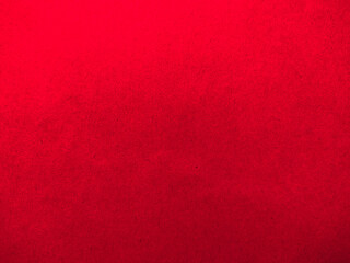 a close-up of a piece of red paper. The paper is smooth and has a slightly glossy finish. The image...