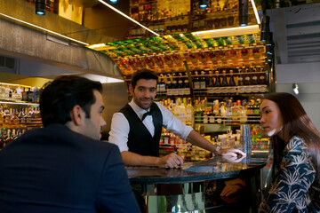 Bartender and customer at night club.