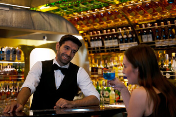 Bartender and customer at night club.