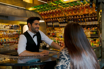 Bartender and customer at night club.