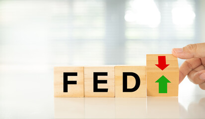 Federal Reserve bank (FED) concept. words of fed and arrow point up or go down on wooden block.