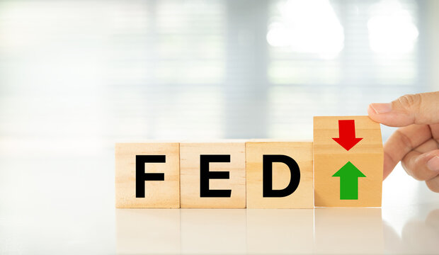 Federal Reserve bank (FED) concept. words of fed and arrow point up or go down on wooden block.