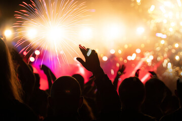 Fototapeta na wymiar Fireworks and crowd celebrating the New year