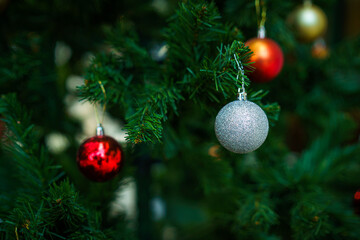 Merry x-mas,Close up of Colorful balls ,gifts box and Christmas greeting picture parcel,bell decoration on Green Christmas tree background Decoration During Christmas and New Year.