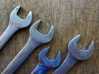 Top view of wrench with different sizes on the wooden board. 