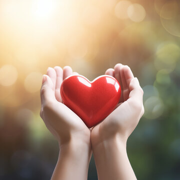 hands holding red heart over bright background, health care, hope, life insurance concept, World Heart Day, world health day 