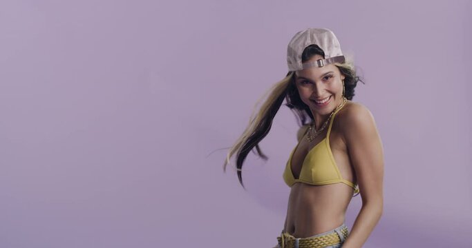 Sexy, woman and happy with cool fashion in studio, purple background or mockup space. Bikini, crop top and portrait of confident person with gen z style, aesthetic and pride for summer with a smile