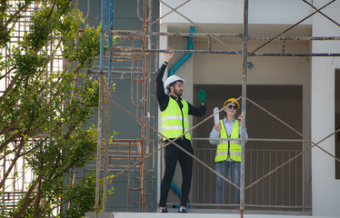 Engineer and architect working on the construction site, double-checking plans and process.