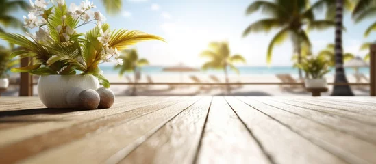 Poster White sand beachside wooden terrace Blur tropical beach, bokeh sun and palm trees in coffee photo room © Muhammad