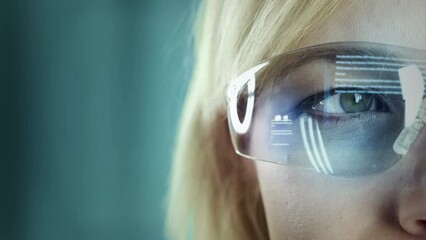 Woman wearing futuristic and technologically advanced glasses. Reading holographic text displayed on glass.