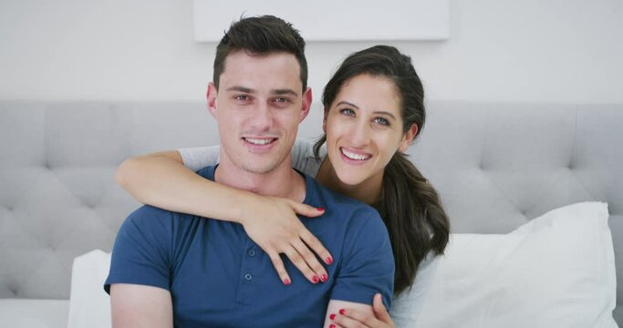 Smile, couple and kiss cheek in bedroom at home, care and together in the morning. Face portrait, man and woman in romantic connection in bed, happy in healthy relationship and love on valentines day