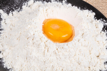 egg yolk in the middle of flour to cook