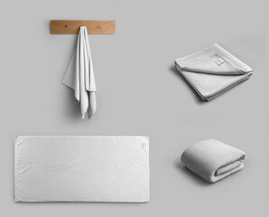 Mockup of a white towel, laid out horizontally, hanging on a hanger, folded towelling for branding....