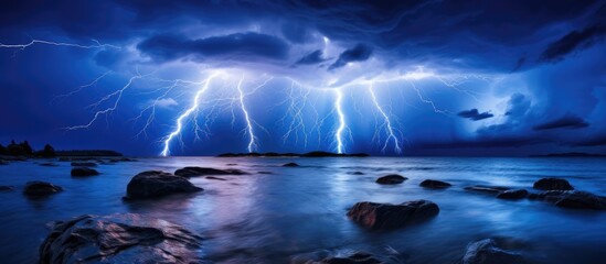 Stunning summer lightning illuminates Atlantic waters at night. - obrazy, fototapety, plakaty