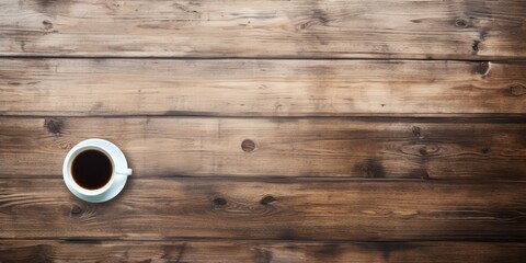Business and finance concept with a blank wooden desk, computer, and coffee viewed from above.