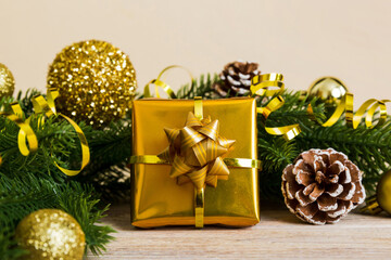 New Year Christmas mood, gift box, branches of a christmas tree, New Year decorations on a colored background