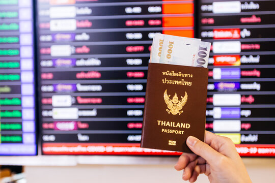 Thailand passport and boarding pass at international airport. Travel concept.