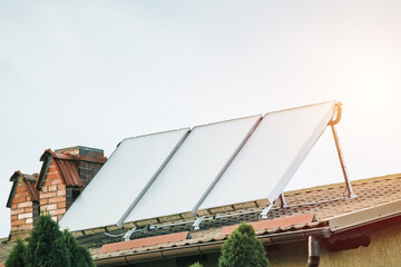 The benefits of using solar energy for water heating in a house. solar panels and thermal...