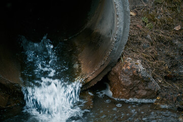 Wastewater sewage flows from a pipe into the river. Tackling Pollution. Managing Wastewater and...