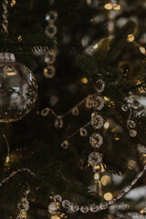 beautiful new year's toys, festive mood, selective focus, against the backdrop of bokeh from the lights of the garland. glass Christmas toys and glass icicles