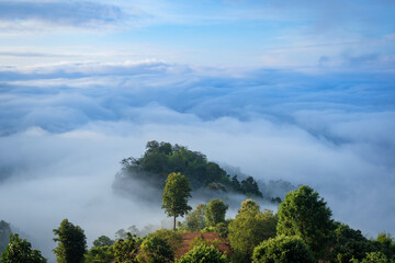 Beautiful natural scenery with a sea of mist around mountain peaks in the morning on the hills...