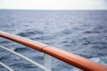 The railing on the ship. Sea view through the railing on board the liner. Background for the text. Space for text. Traveling on a cruise ship. The expanse of the ocean