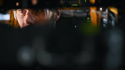 Young man is working with internet equipment and wires in server room