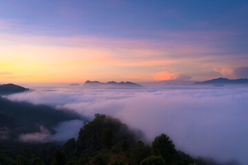 Beautiful natural scenery with a sea of mist on mountain peaks in the morning on the hills at Glo Selo Viewpoint at Mae Hong Son, Northern Thailand.