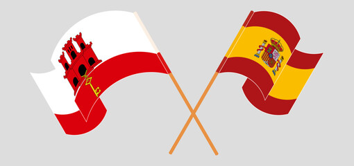 Crossed and waving flags of Gibraltar and Spain
