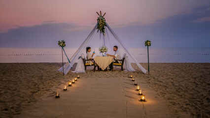 Romantic dinner on the beach, honeymoon dinner on the beach during sunset Thailand, Valentine...