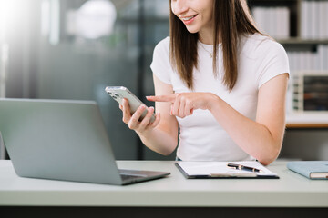 Businesswoman working on laptop, tablet and smartphone at her workplace at office..