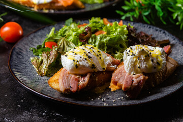 Toast with poached egg in a plate. Salad