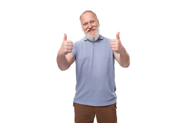 Fototapeta premium a handsome elderly man with a gray beard and mustache in a T-shirt is full of energy and health