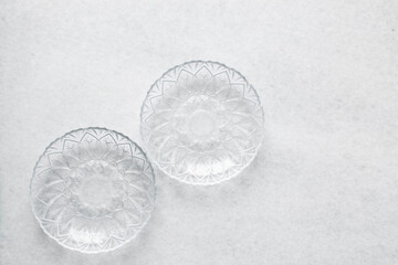 Top view of glass plates on a marble table, crystal glass plate for meal prep