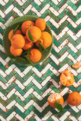 Green tile table and plate with Turkish mandarins or Bodrum Mandalinası