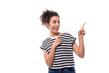 a young caucasian woman with a curly haircut is dressed in a striped summer t-shirt enthusiastically actively gesturing