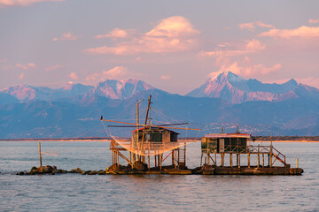 View of Marina di Pisa trabucchi and Alps at sunset, Pisa, Italy