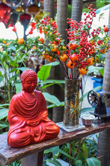 buddha statue and artificial decorations fruits as symbol of wealth for Tet Lunar New Year