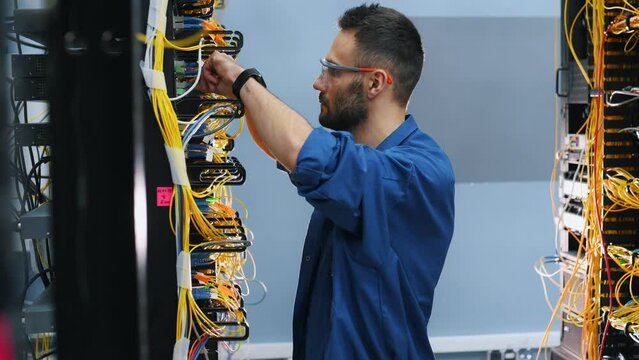 Server technician putting UTP cable into crimping pliers